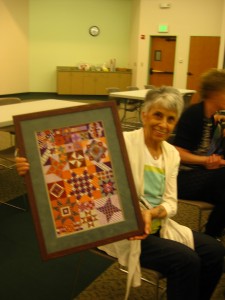 Barb shows a magnificent finished piece at a recent Show & Tell.