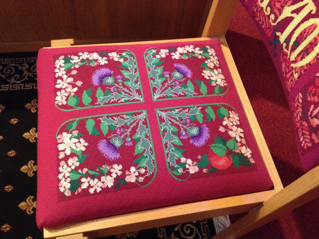 Needlepoint chair seat in glorious colors.